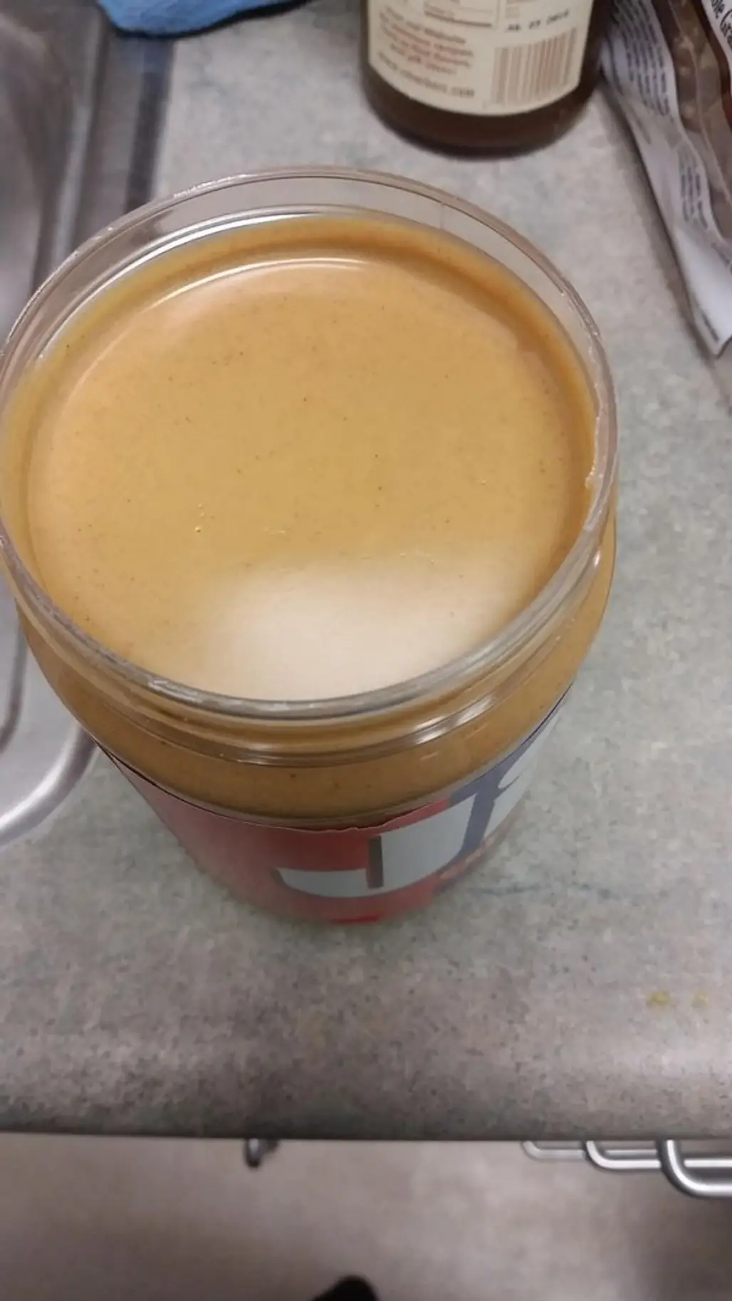 Breaking the Smooth Surface on a New Jar of Peanut Butter
