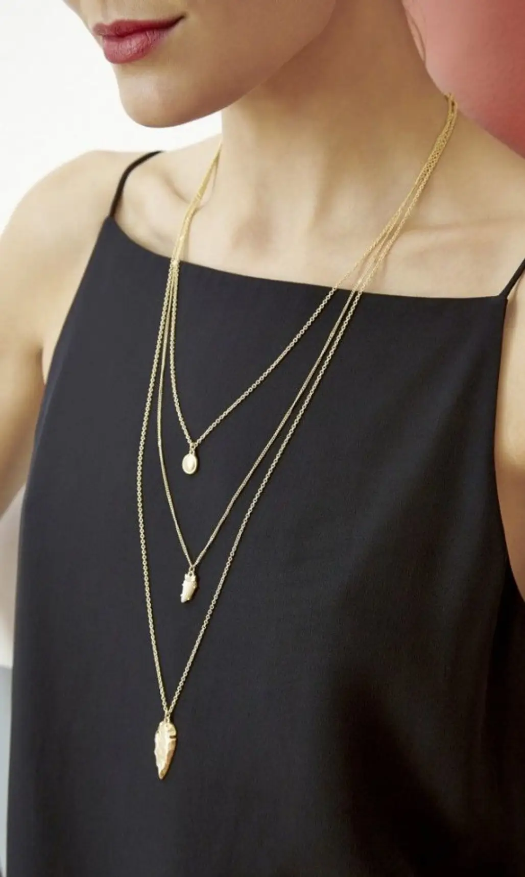 A Three Tiered Necklace Glams up a Simple Top