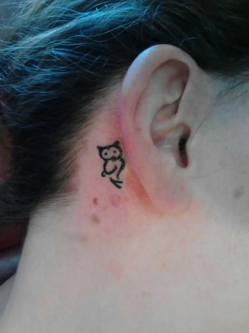 Single needle tribal tattoo located on the neck.