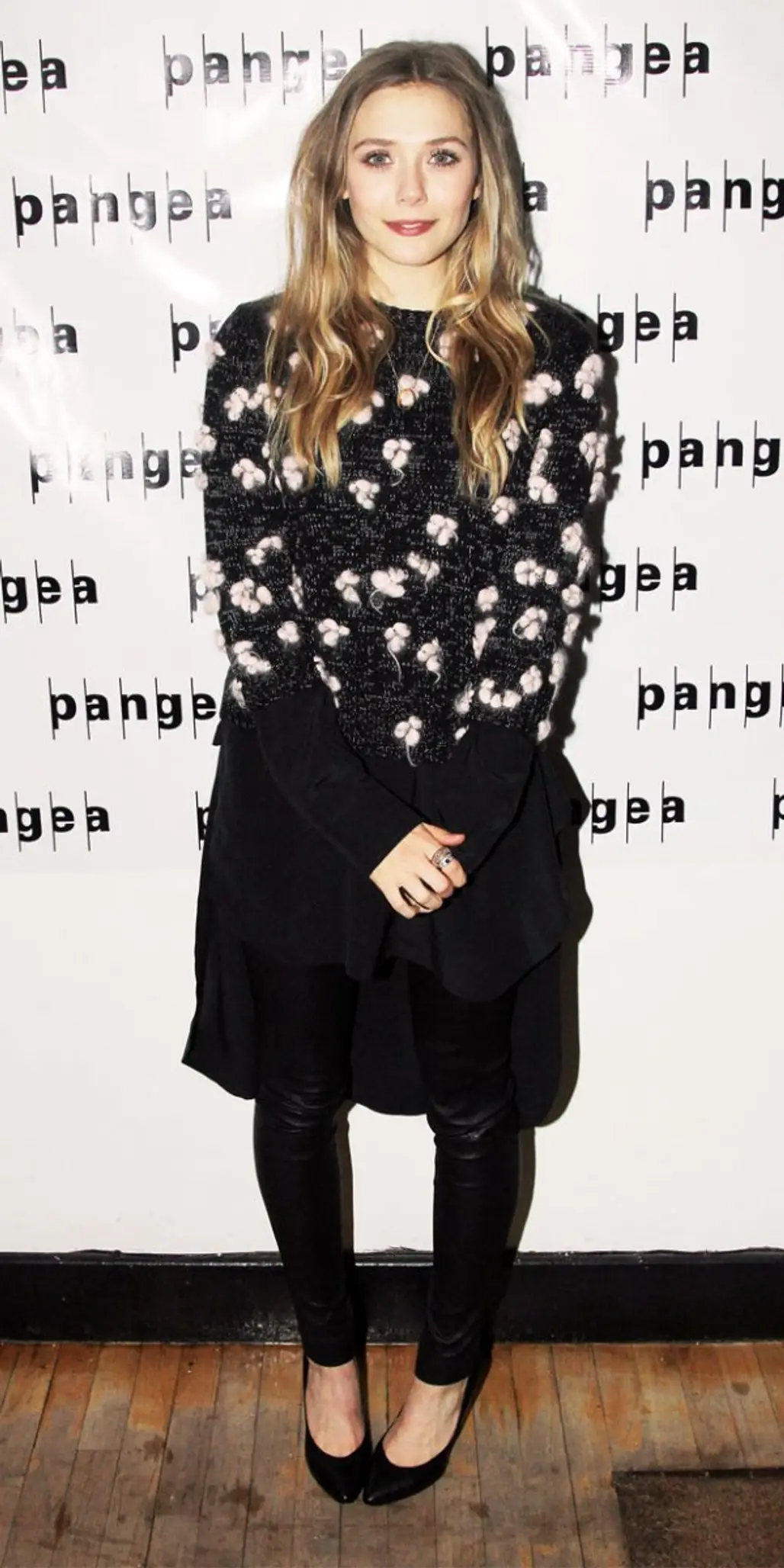 If You're Afraid That Your Leggings Outline Your Shape a Little Too Well, You Can Opt to Add Layers. Elizabeth Olsen Looks Cozy in Her Tunic and Sweater Top