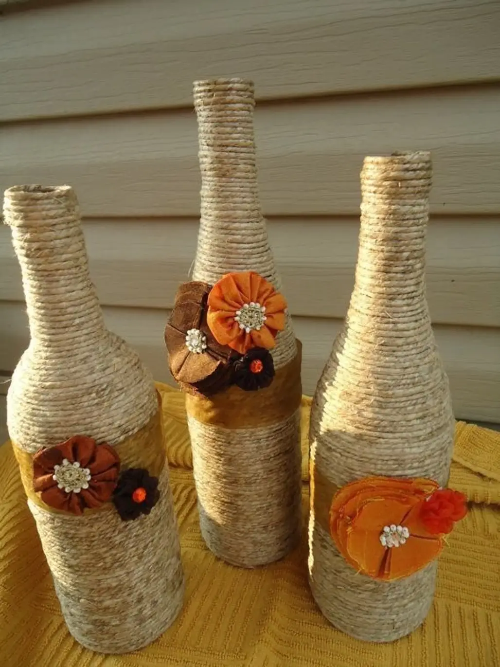 DIY Decorative Wine Bottles Wrapped with Twine and Fabric Flowers