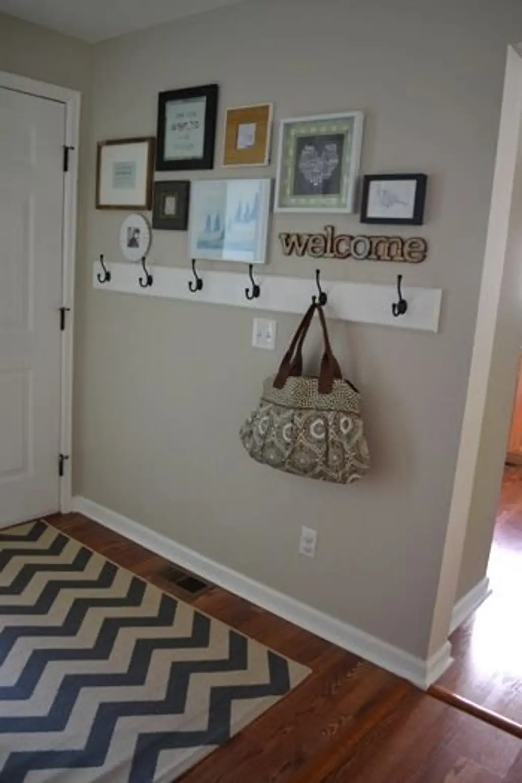 Hooks with Mismatched Picture Frames over Top