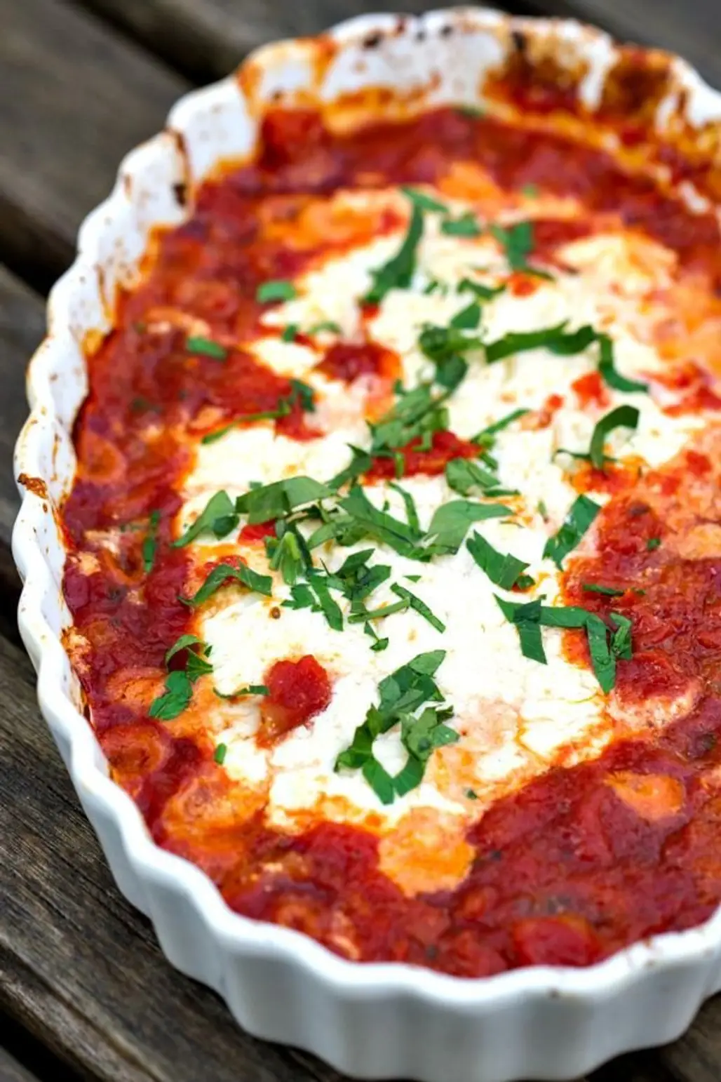 Baked Goat Cheese Topped with Marinara Sauce and Basil