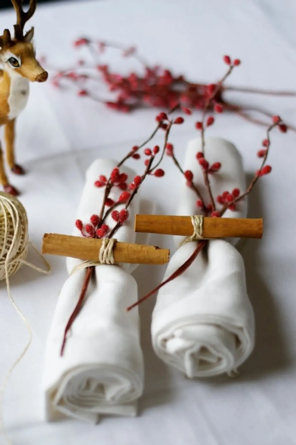 White Napkins with Cinnamon Sticks and Red Berries