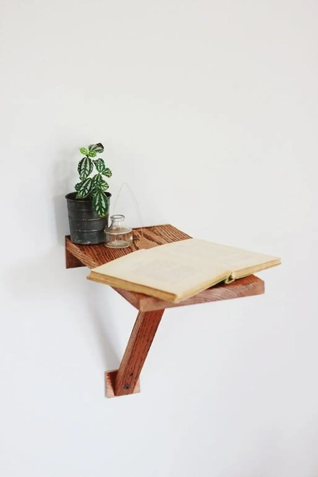 One Wall Bracket, One Scrap of Wood = Instant Side Table