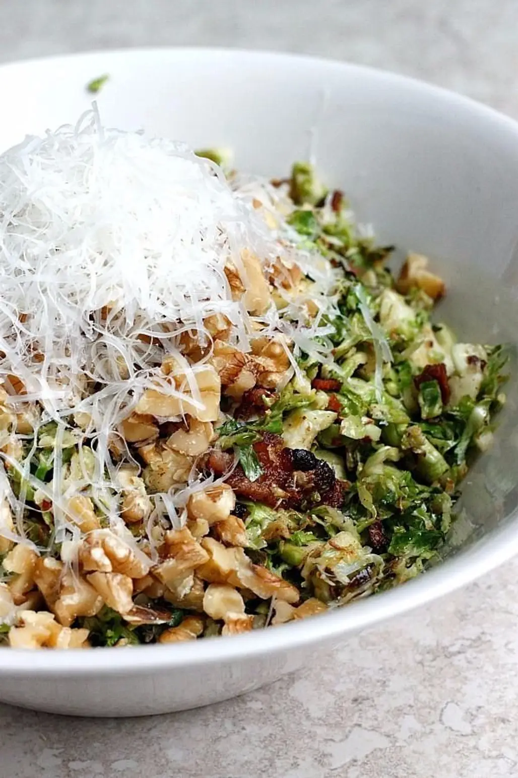 Warm Bacon and Brussels Sprouts Shredded Salad Tossed with Chopped Walnuts and Fresh Parmesan