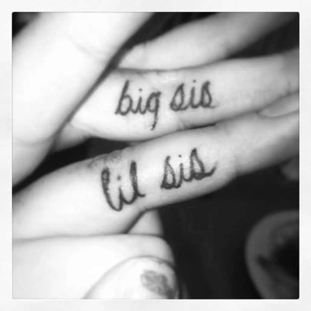 Twin sisters matching tattoos on the finger