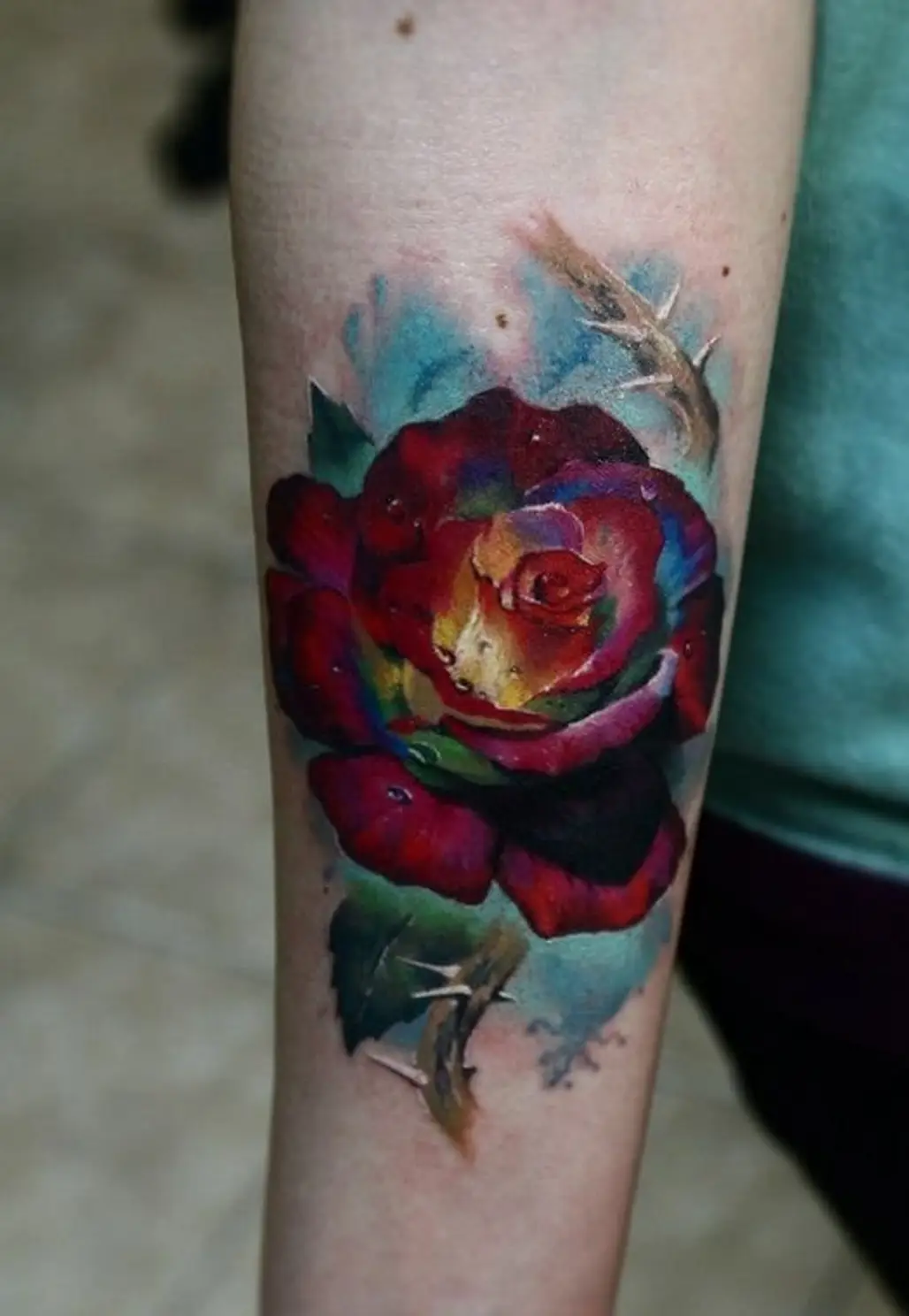 tattoo,red,flower,arm,tattoo artist,