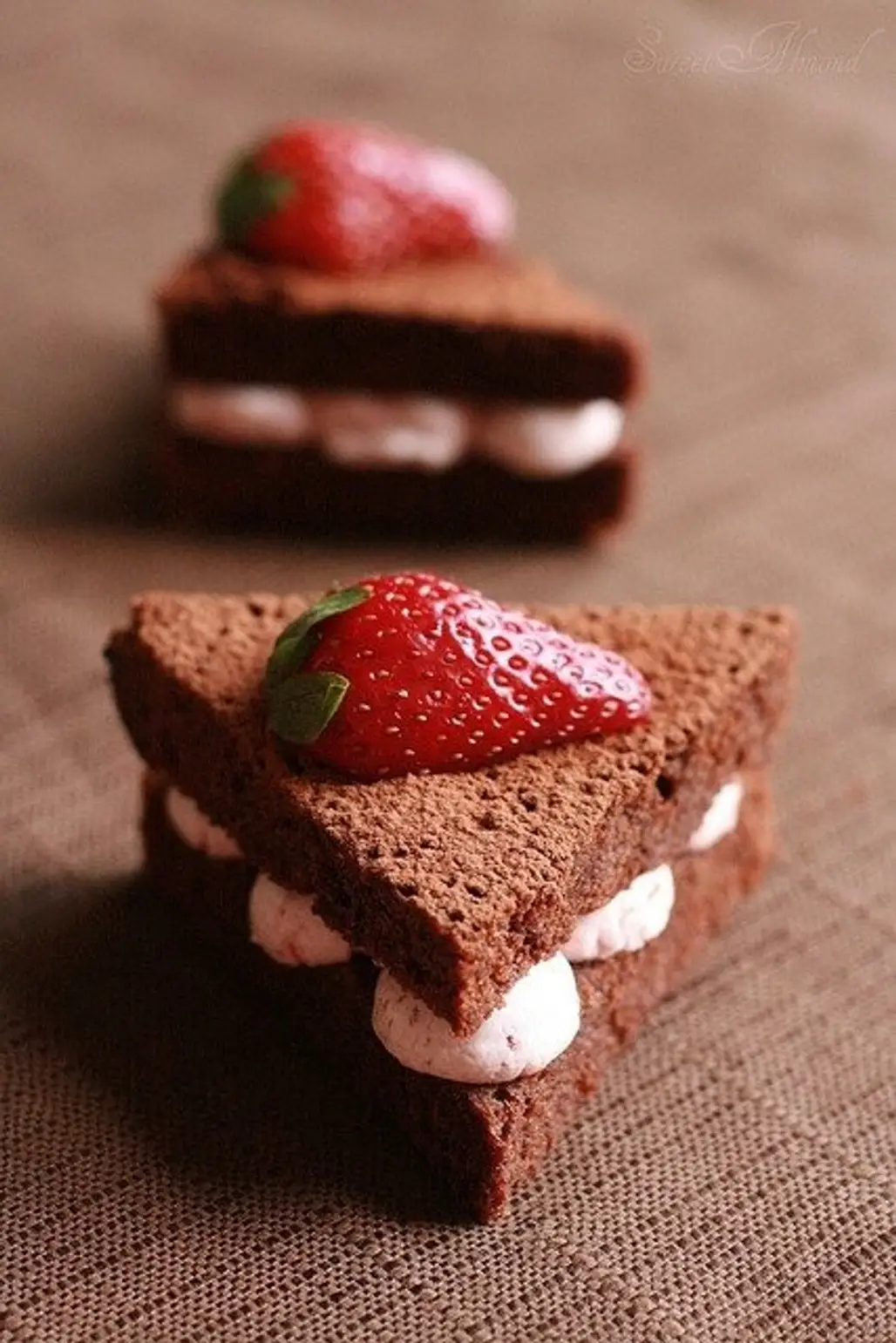 Chocolate Cake Sandwich..cut Triangles of Chocolate Cake, Pipe Frosting in between the "sandwich" and Add a Strawberry!