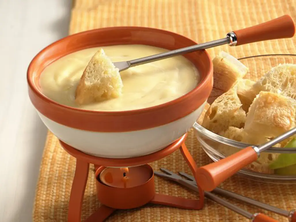 Fish Cheesy Bread out of a Fondue in the Swiss Alps