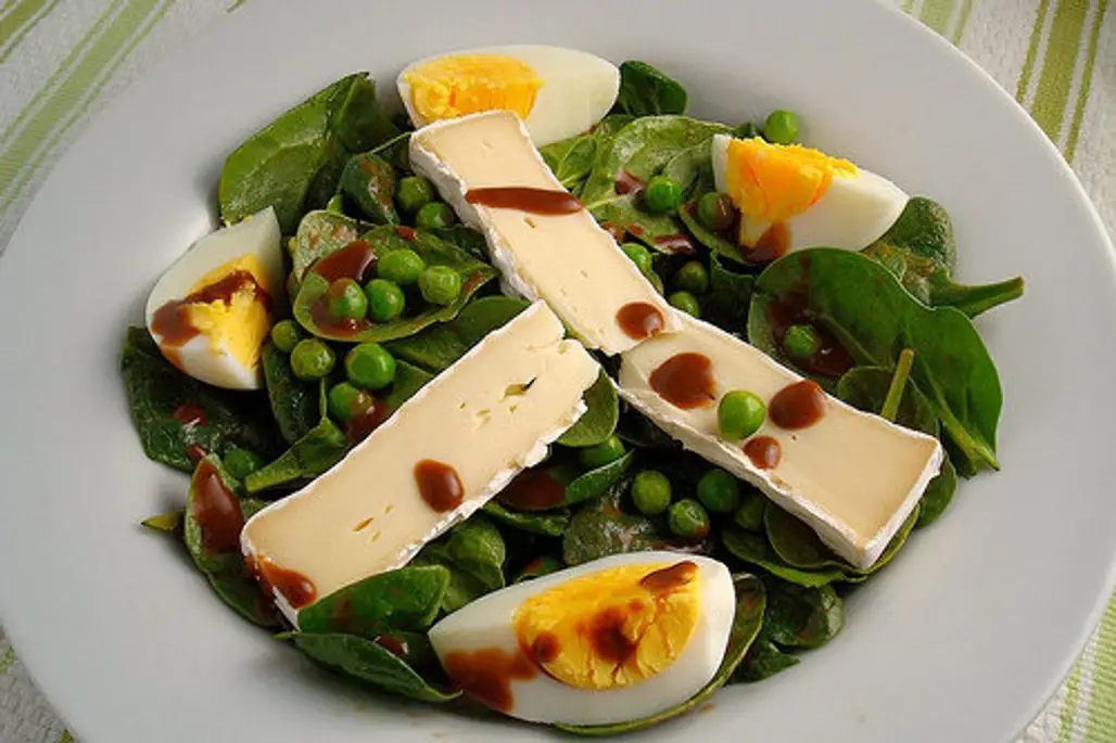 Eggs on Baby Spinach with Peas and Brie