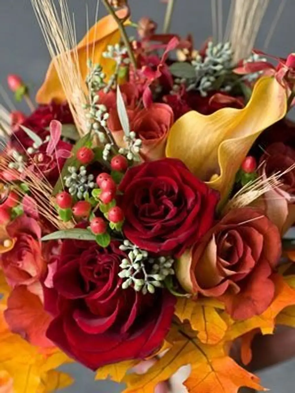 Roses, Calla Lilies, Mokara Orchids, Hypericum Berries, Eucalyptus Rounded out with Fall Leaves