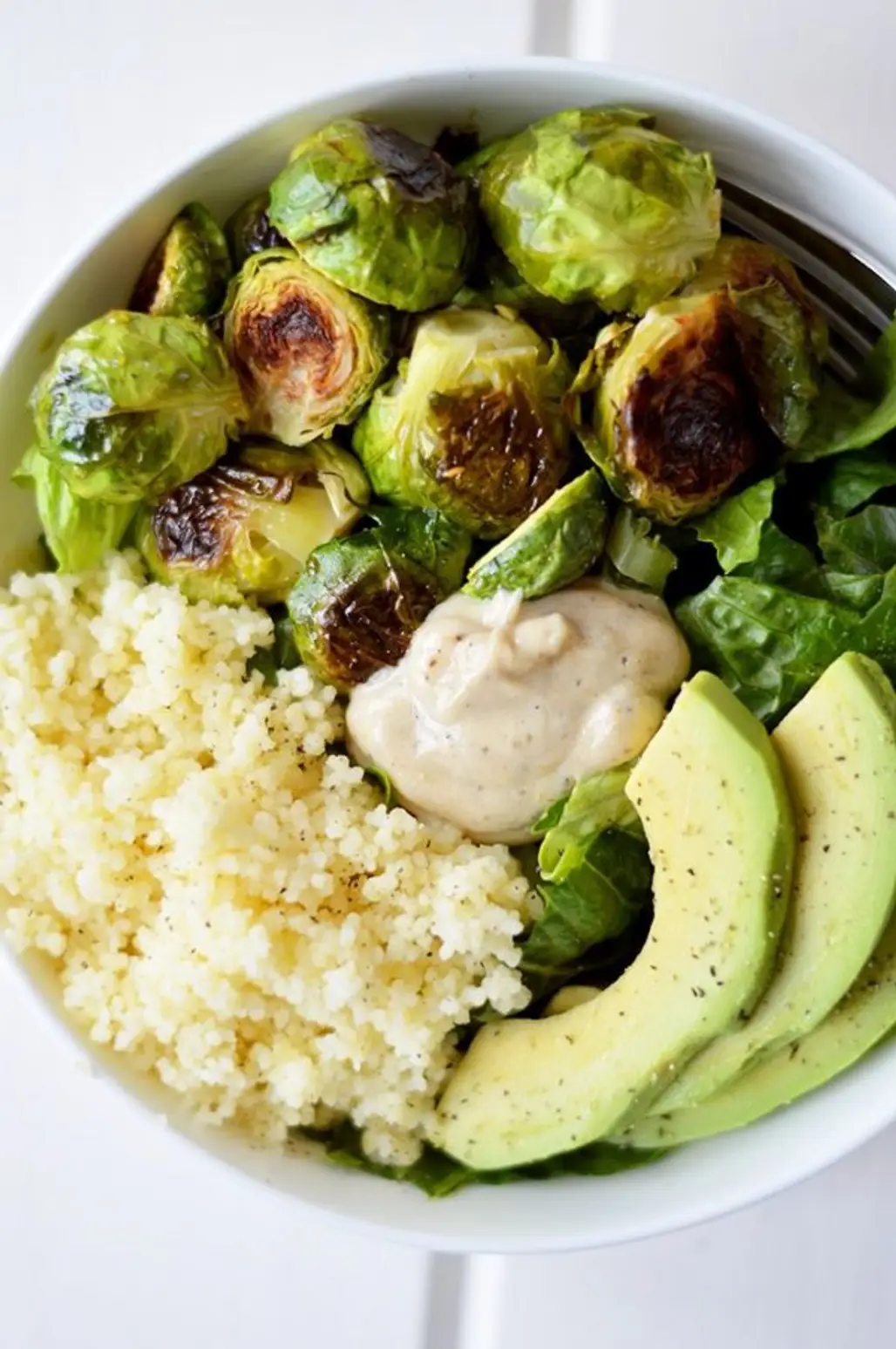 Packed with Dark Leafy Greens, Crispy Roasted Brussels Sprouts, Fluffy Couscous, Creamy Avocado and a Super Simple Vinaigrette