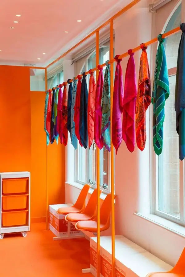 Orange, Clothes hanger, Room, Interior design, Textile,